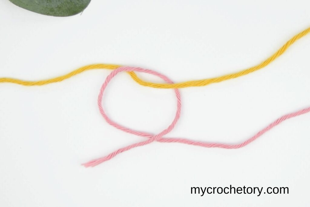 Loop formed in the magic knot for joining yarn, showing the process step.