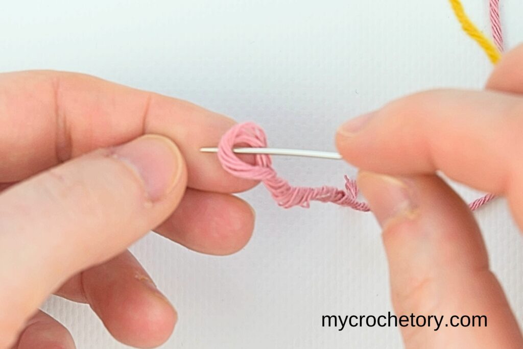 Creating a loop in yellow yarn during how to do a Russian join.