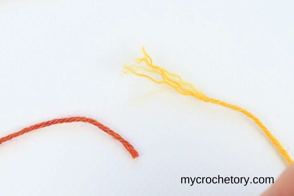 Two yarn ends unraveled and ready for the first step in how to join yarn ends.