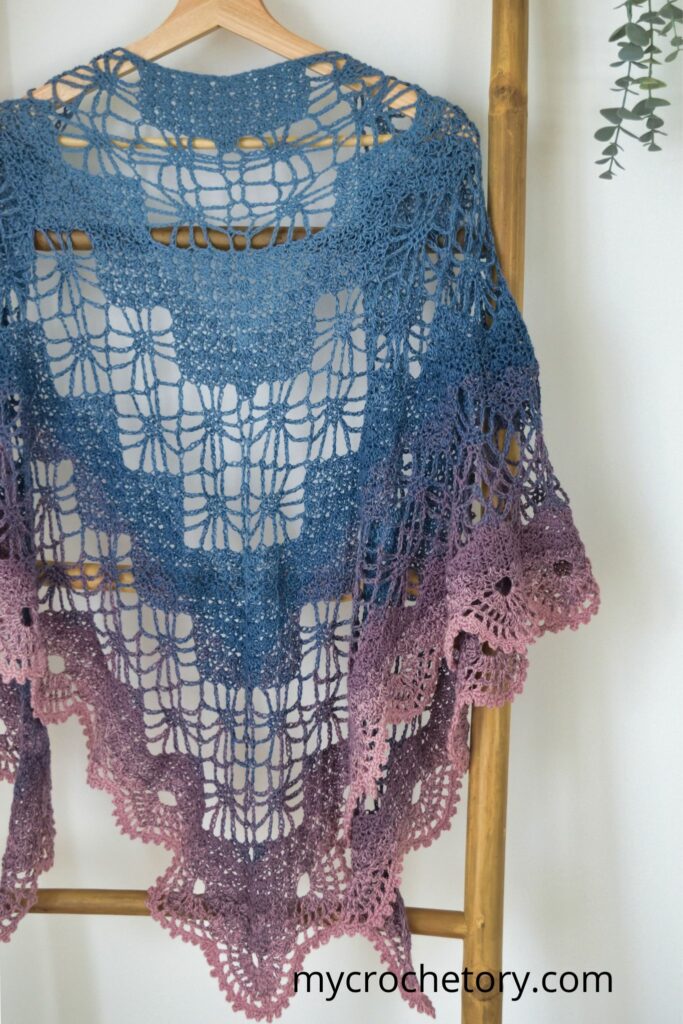 Arys Shawl displayed on a hanger, highlighting its intricate Diagram Triangle Crochet Shawl Pattern.