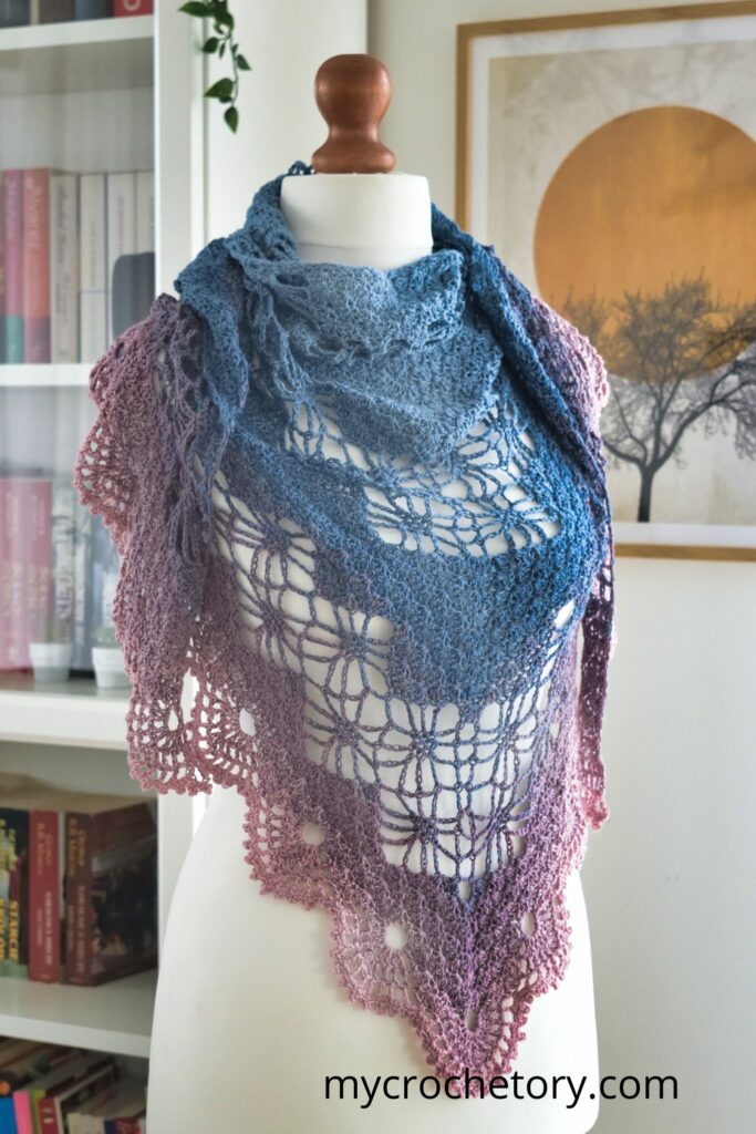 Mannequin wearing Arys Shawl, emphasizing its stylish Diagram Triangle Crochet Shawl Pattern.