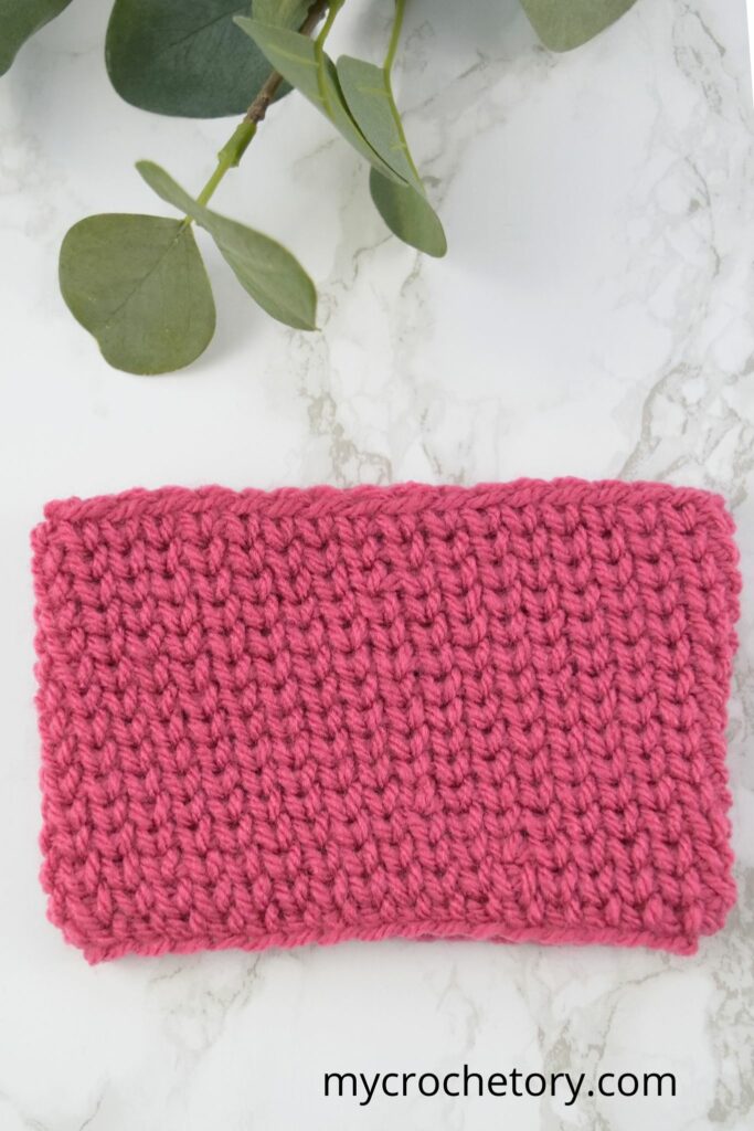 Detailed view of the knit-like texture created by the crochet waistcoat stitch.
