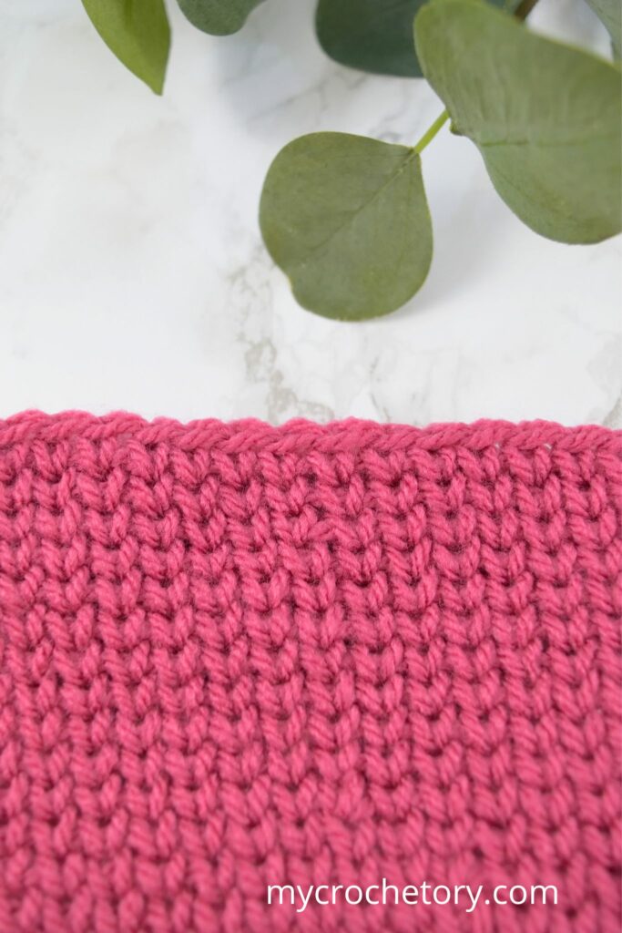 Close-up of crochet waistcoat stitch in the round.
