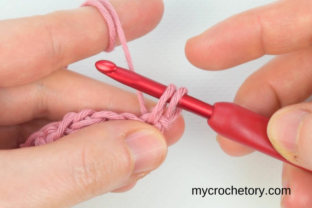Inserting hook into the first stitch of the new row – how to crochet straight edges in single crochet