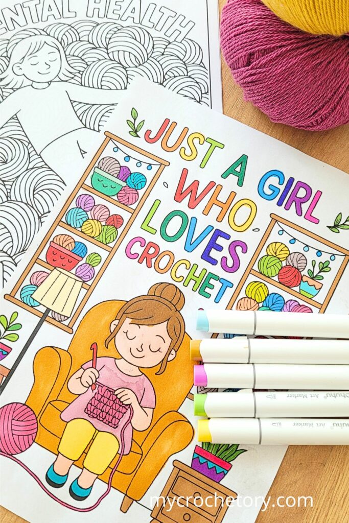 Brightly colored ‘Just a Girl Who Loves Crochet’ page and ‘Mental Health Matters’ page from a crochet coloring book on a wooden table.
