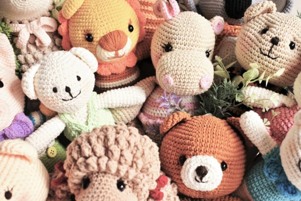 Group of finished animal amigurumi plushies with expressive faces — outcome of applying easy crochet amigurumi hacks.