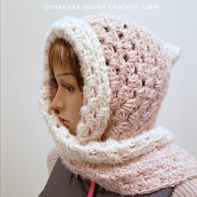 Pink and cream crochet hooded scarf from Oombawka Design, featuring soft textured stitches and warm hood.