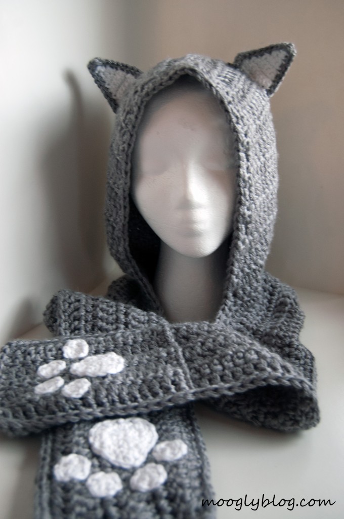 gray crochet hooded scarf with cat ears and paw-print details, styled as a playful crochet scoodie.