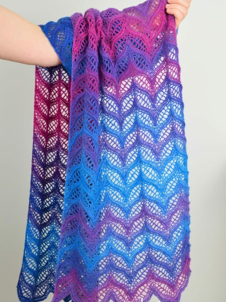 	Tonnta lightweight crochet scarf with pink and blue wavy chevron lace