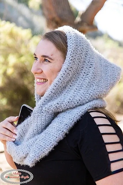 Woman wearing a soft gray crochet infinity hooded scarf, perfect for keeping cozy on chilly days.