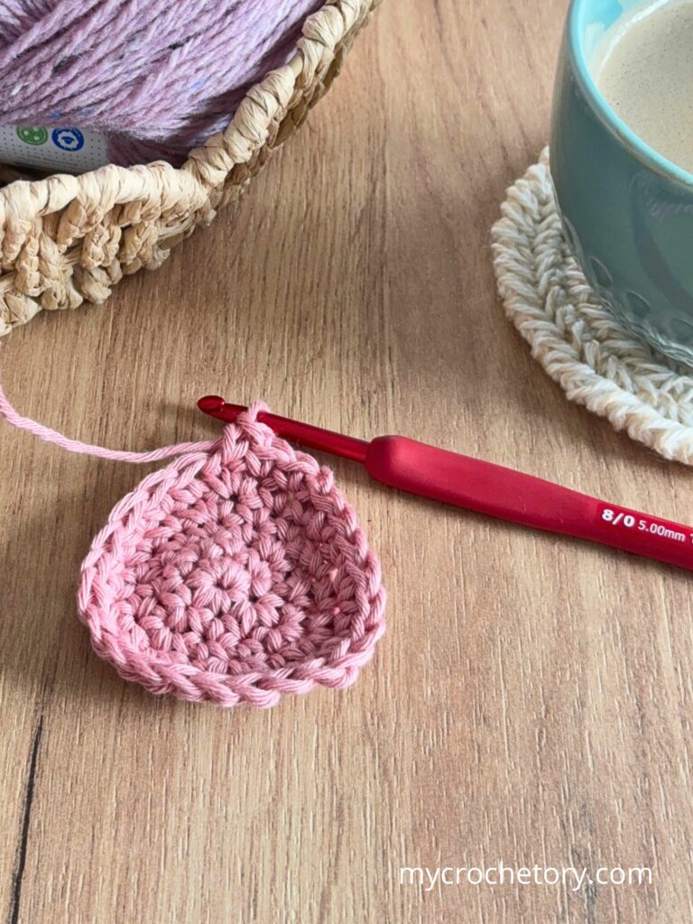 Small crochet circle starting to curl at the edges, demonstrating what happens when there are not enough increases