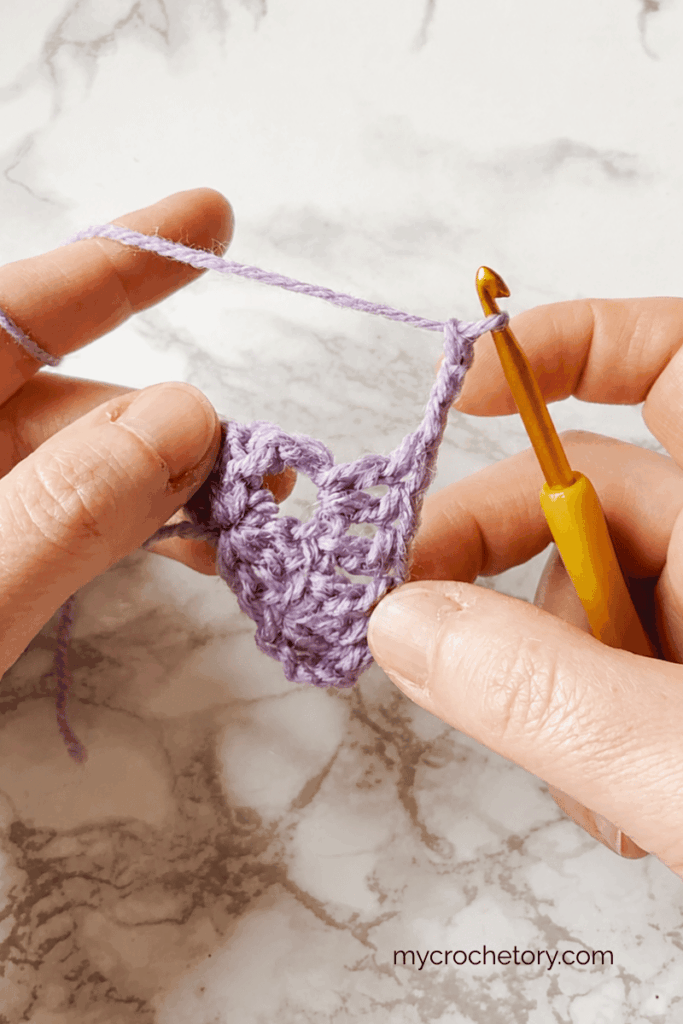Working double crochet stitches toward the center space