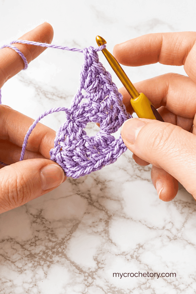 Early stages of a top down triangle crochet shawl worked in double crochet