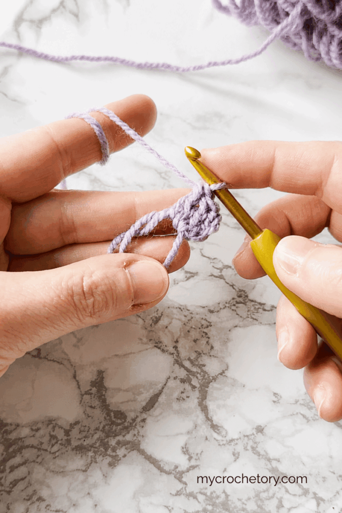 Crocheting the first double crochet stitches into a magic ring