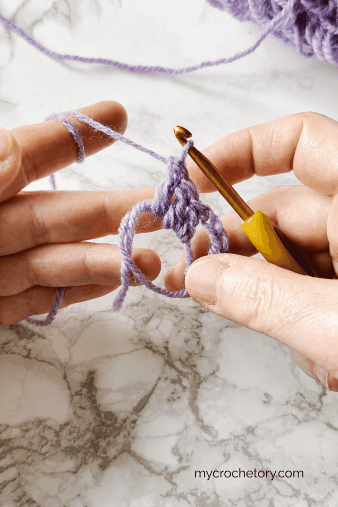 Working double crochet stitches for Row 1 of a triangle shawl
