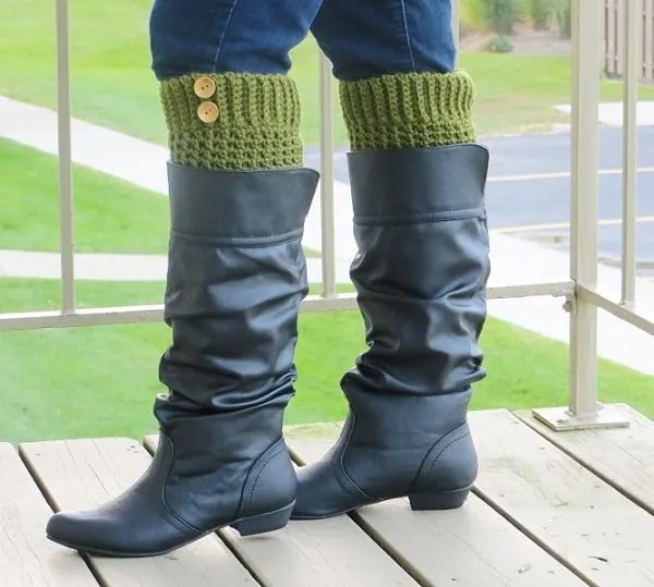 Brooklyn crochet boot cuffs in olive green with two wooden buttons, worn with black boots