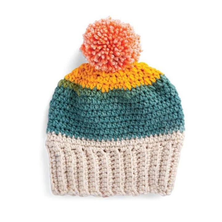Beginner crochet hat with cream ribbing, teal and orange stripes and a pom pom