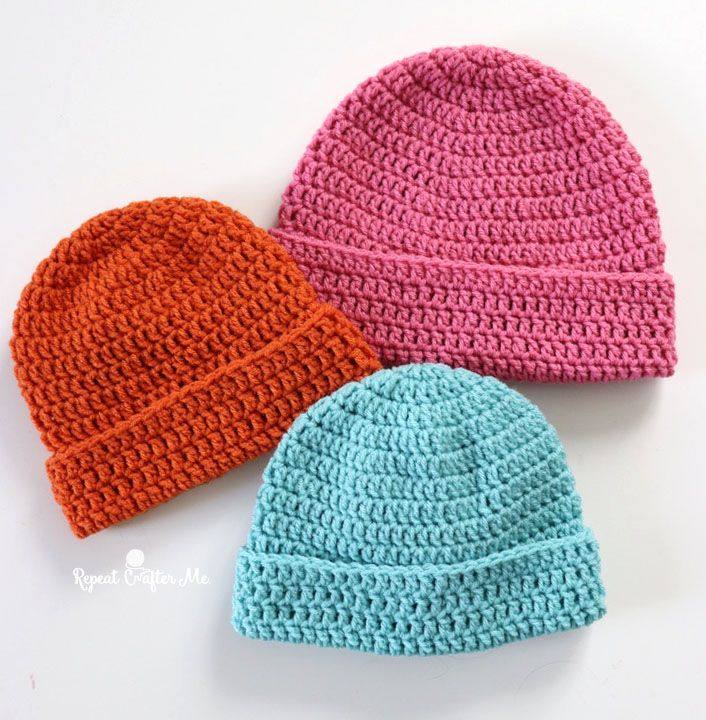 Three folded cuff crochet beanies in orange, pink and turquoise