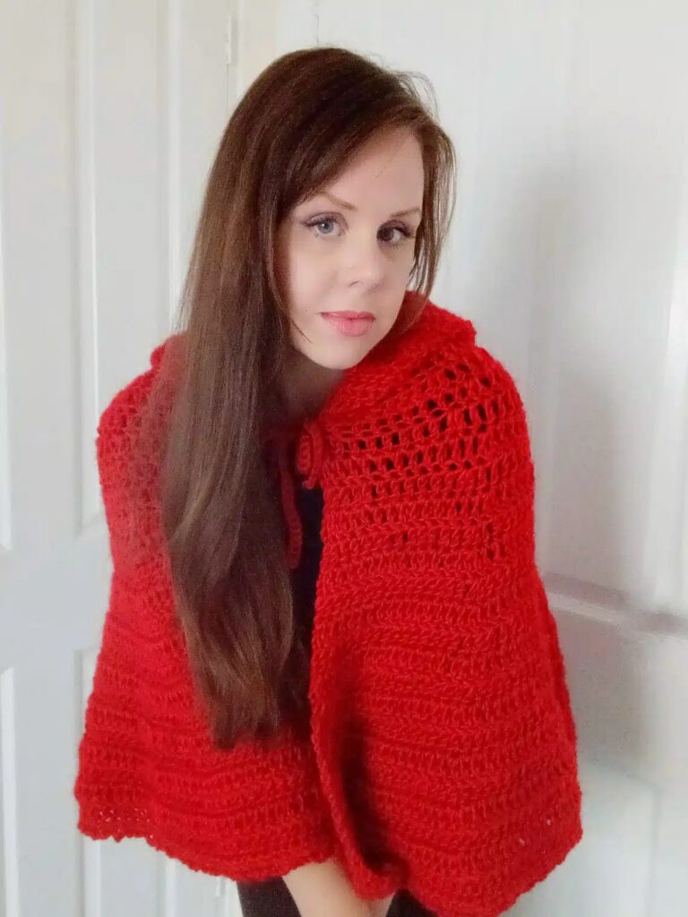 Woman in a red crochet hooded shawl with a lacy band, Little Red Riding Hood costume