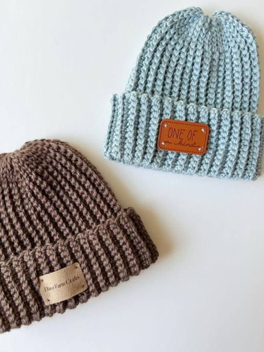 Brown and light blue ribbed crochet beanies with folded brims and leather tags