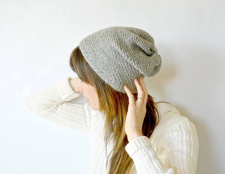 Woman wearing a gray slouchy moss stitch crochet beanie