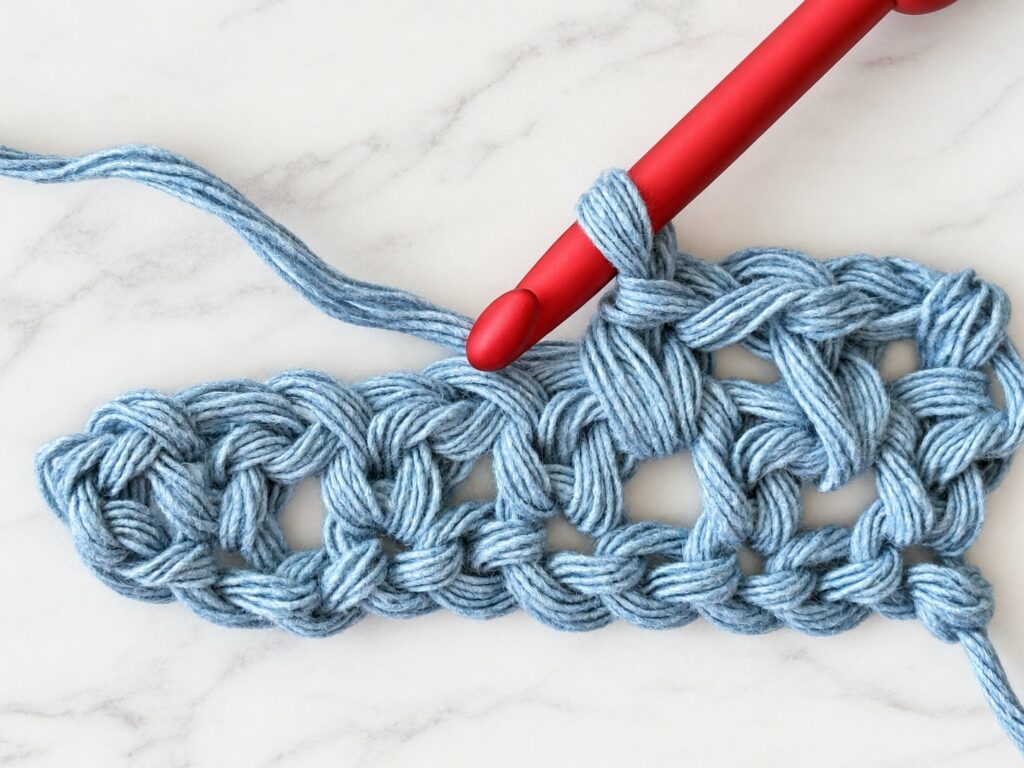 Moss stitch row 2 with the hook going into a ch-1 space