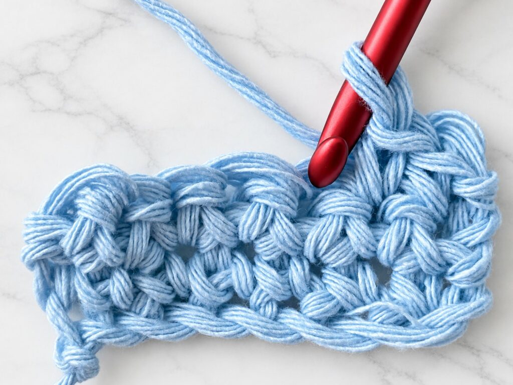 Crochet hook going into a stitch