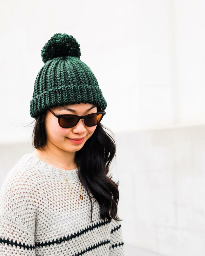 Alpi ribbed crochet beanie in dark green with a big pom pom