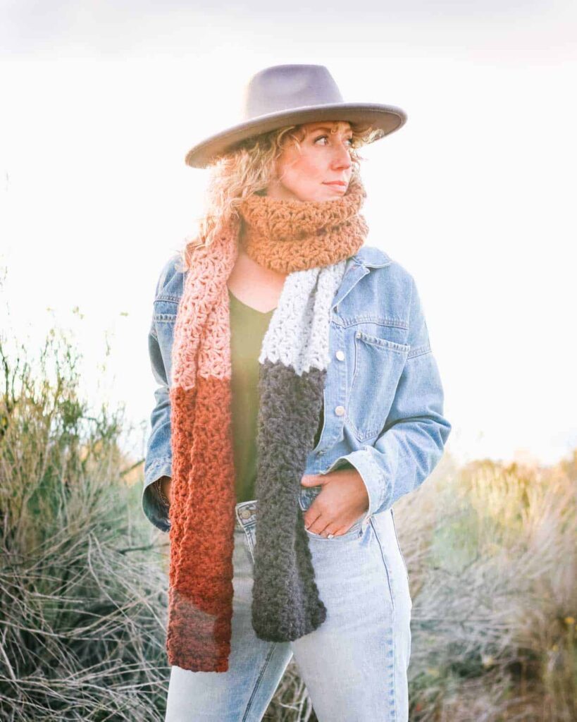 Cinque color-block crochet scarf in peach, rust, gray and white, worn with a denim jacket
