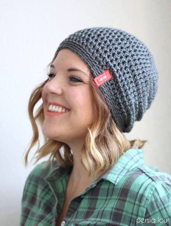 Smiling woman wearing a gray slouchy crochet hat
