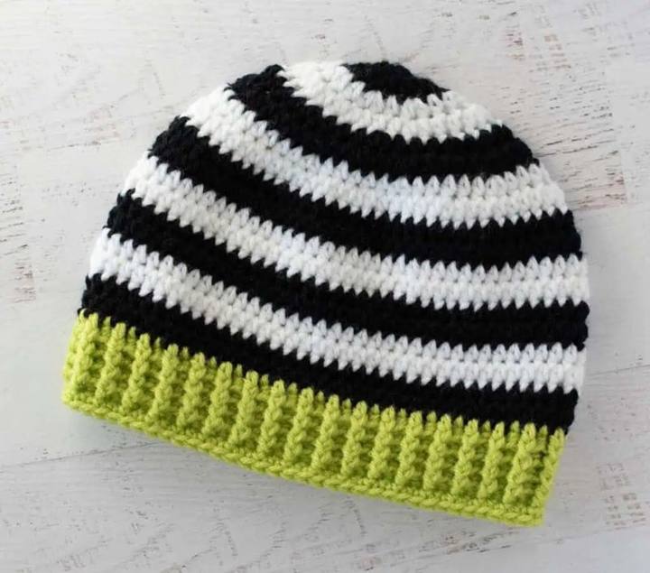 Black and white striped crochet beanie with a lime green ribbed brim