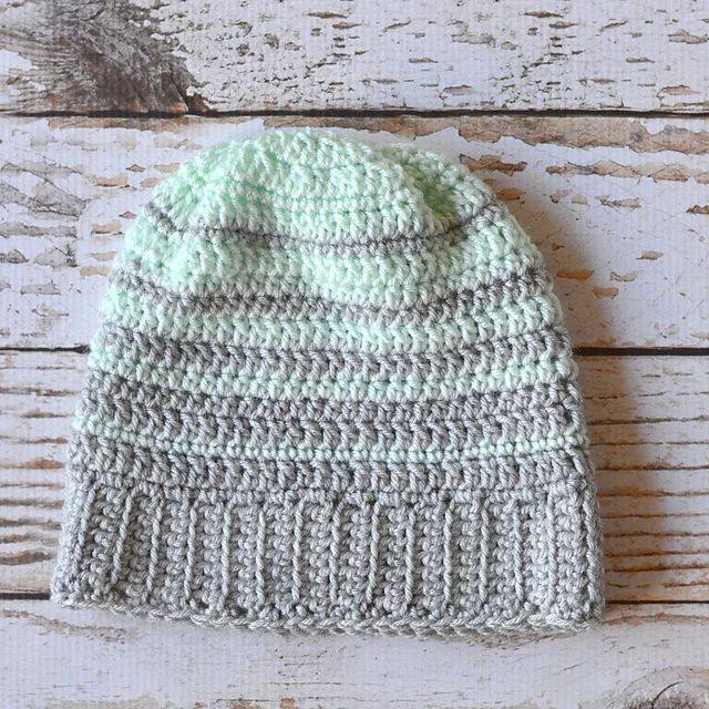 Mint and gray striped slouchy crochet beanie lying flat